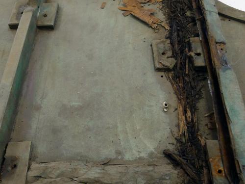 A section of lumber on a World War II era aircraft. The outer section of lumber is mostly intact, whereas the inner section of lumber on the right is rotted.