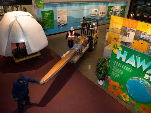 A trolley is used to transport a large wooden blade belonging to a wind tunnel fan in the Museum.