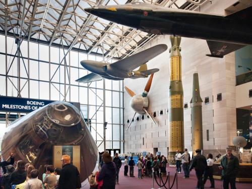 A large wind tunnel fan previously used by NASA hangs on a wall of the Museum's Washington, D.C. building alongside other museum objects.