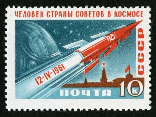 Russian ten-kopek stamp commemorating the first human spaceflight accomplished by Yuri Gagarin. The stamp features a depiction of a red rocket soaring above a Kremlin building, with a depiction of Gagarin in the sky.