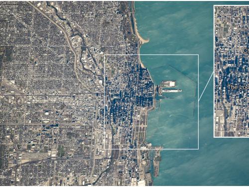 Satellite view of the city of Chicago and the adjacent Lake Michigan. A close-up panel shows the city in further detail.