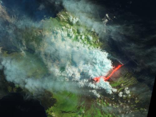 Satellite view of an erupting volcano in the Galapagos Islands. The view has been edited to show different colors which represent different aspects of the photo.