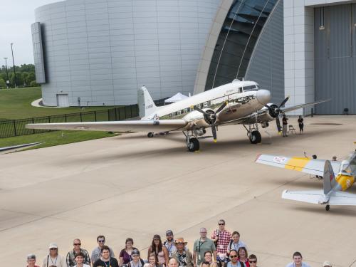 Group photo of social media participants, social media staff members of the Museum, the Museum's former director, and astronaut Clay Anderson outside together during a flight-themed Museum event.