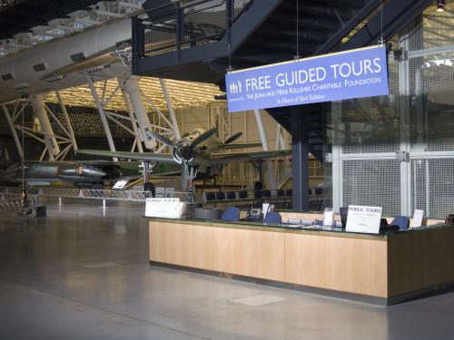 Diagonal front view of a guided tours desk inside the Steven F. Udvar-Hazy Center. The desk is located near a popular reconnaissance aircraft in the Museum's collection.