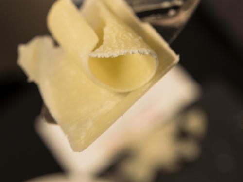 Close-up view of a slice of light yellow-colored cheese.