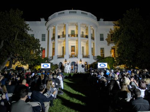 View of the White House exterior during an astronomy event held there. President Obama is speaking to a group of people.