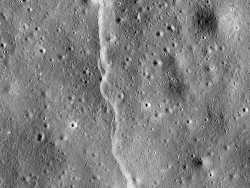 A line-shaped cliff feature is visible on a section of the Moon.