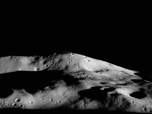 A tall mountain summit on one of the Moon's polar regions that receives some sunlight due to its impressive height.