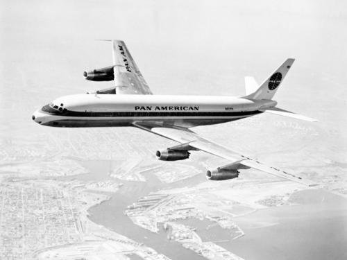 Side view of commercial aircraft with four engines and Pan American Airways livery. Aircraft is in flight.