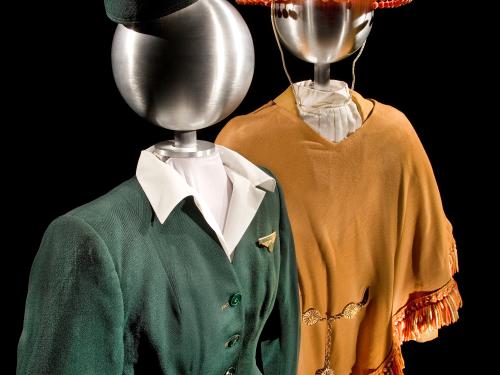 One stewardess uniform, styled on a mannequin. The uniform consists of a red sombrero and brown blouse.