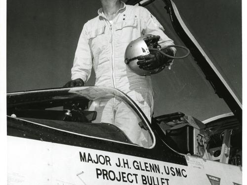 John Glenn standing in the cockpit his F8U-1P Crusader