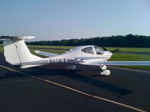 Side view of white monoplane with single engine. Behind the cockpit the registration number "N811ET" is painted in black.