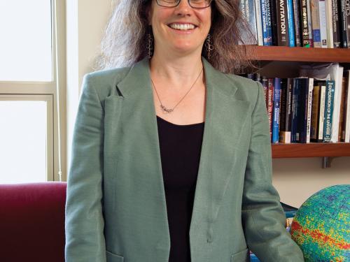 Andrea M. Ghez, a white woman, poses for a professional photo.