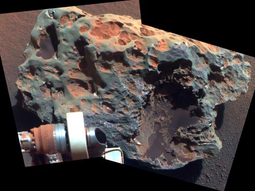 A large meteorite found and tested on Mars by Opportunity Rover, whose arm is visible in the view of the meteorite.