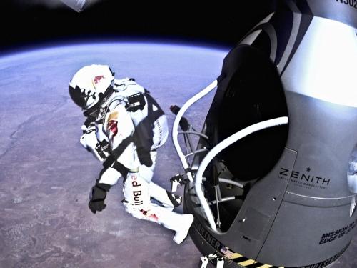 Felix Baumgartner, a pilot wearing a white high-altitude suit, jumps from near space as part of a flight test.