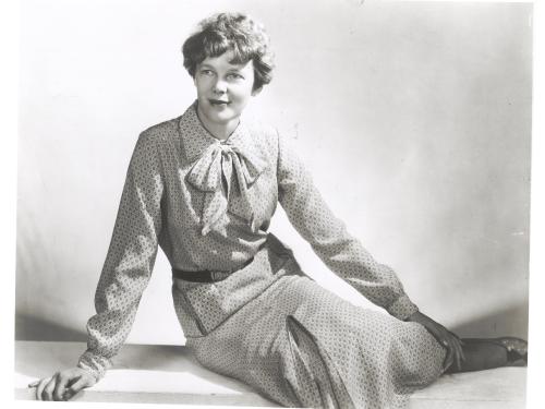 Amelia Earhart sits as she models clothing that she designed and made herself.