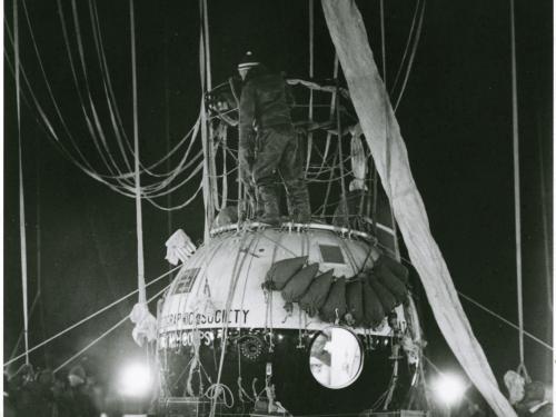 Close-up view of the large gondola of an air balloon with a light and dark colored base.