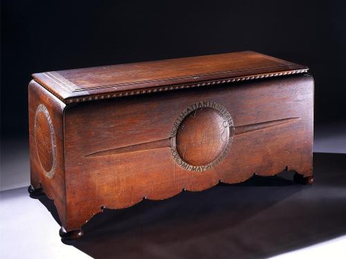 Wooden chest commissioned to hold the trophies, plaques, and memorabilia belonging to Amelia Earhart. The chest features motifs highlighting three of Earhart's milestone flights.