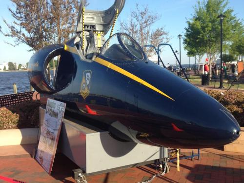 Diagonal front view of the single-person cockpit of a yellow and black cockpit.