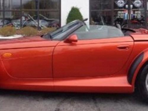 Side view of red, two-seat convertible automobile.