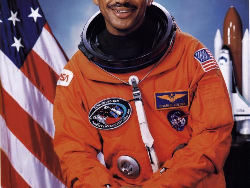 Charles F. Bolden Jr., an African-American male astronaut, poses formally in his astronaut suit.