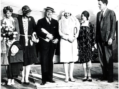 Amelia Earhart, a white woman, stands with other white people including Charles and Anne Lindbergh, featured on the right.