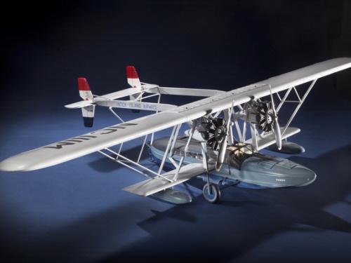 Diagonal front view of white-colored monoplane model. 