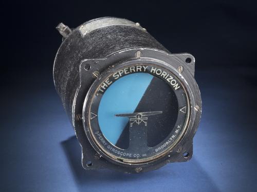 Black, cylinder-shaped altitude tool. Tool features two colours, one dark blue and one light blue. The manufacturer details are placed on the frame surrounding the blue sections.