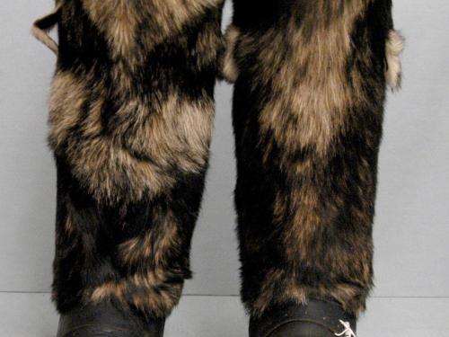 Pair of survival boots with black leather base and black and tan-brown fur on the sleeves.