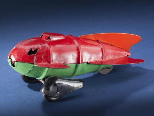 Side view of red and light green teardrop-shaped rocket ship. 