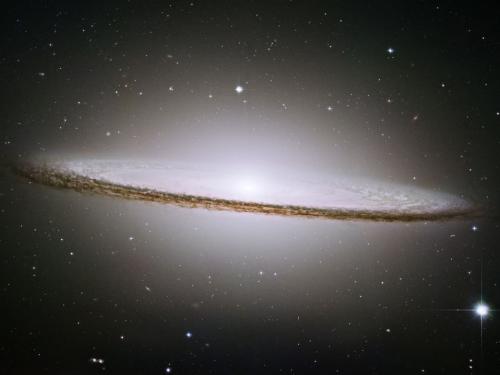 A disc-shaped galaxy that looks slightly like a sombrero.