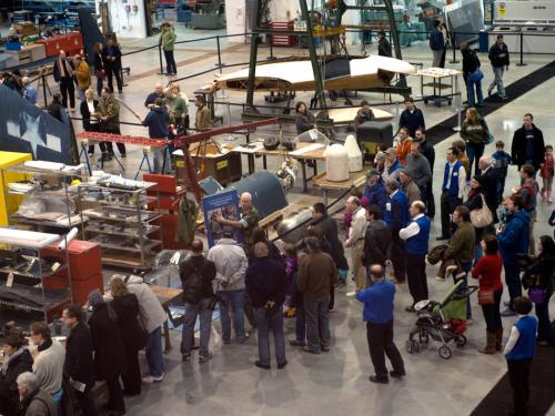 Second-floor view of Museum visitors touring the Museum's restoration hangar during an open house event.