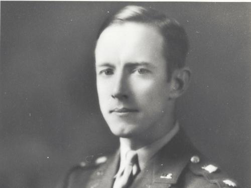 A white man in a military uniform looks at the camera.