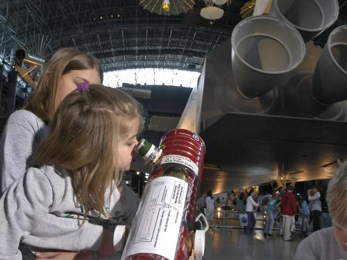 Girl Looks through Telescope at Udvar-Hazy Center