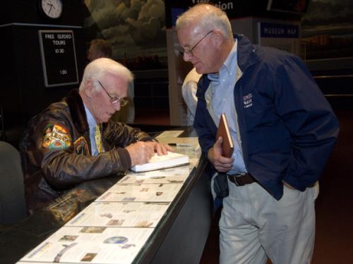 Astronaut Gene Cernan Signs an Autograph