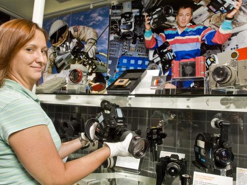 Museum Specialist installing the Space Camera Exhibit Case