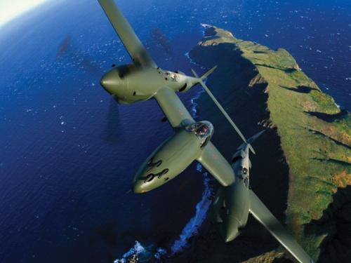 Glacier Girl P-38 in flight over coastline