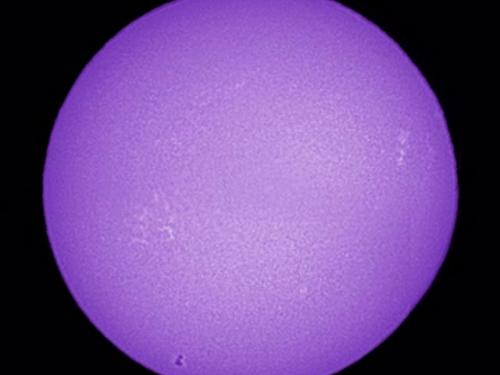 A view of the Sun using a telescope that provides purple images.