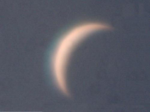 View of Venus as a thin waning crescent during daytime.