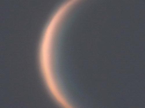 View of Venus as a thin waxing crescent during daytime hours.