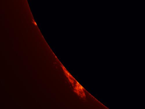 Partial view of the Sun's surface with an emphasis on two prominences floating away from the surface of the Sun.