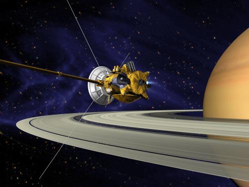 An artist's vision of the Cassini spacecraft, a yellow and white spacecraft with long probes, prepares to enter Saturn's orbit.