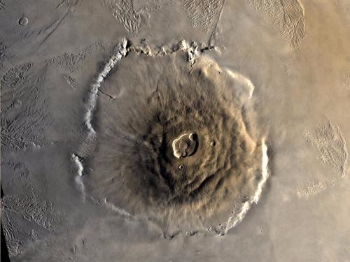 A satellite view of a large volcano on the surface of Mars.