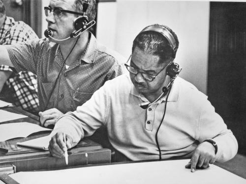 Vance H. Marchbanks Jr., an African-American male flight surgeon, looks at medical charts during the "Friendship 7" mission.