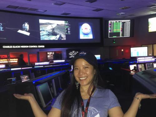 Programmer Melody Ho standing inside mission control at the NASA Jet Propulsion Lab