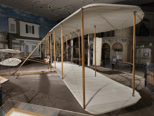 Side of wood, fabric, and metal canard biplane 1903 Wright Flyer in museum