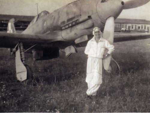 man in white flight suit in front of aircraft 