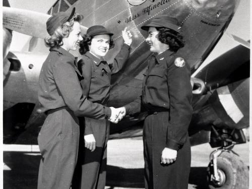 Three women in front of aircraft