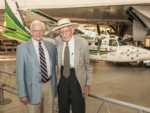 The Museum's director and famed pilot stand beside Hoover's green and white Shrike Commander. 