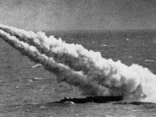 Grainy, black and white photo of a missile taking off a submarine.